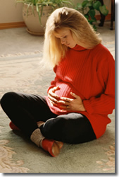 Pregnant woman holding stomach