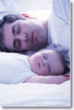 father and baby sleeping